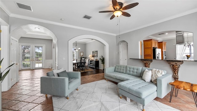 living room featuring crown molding, french doors, and ceiling fan with notable chandelier