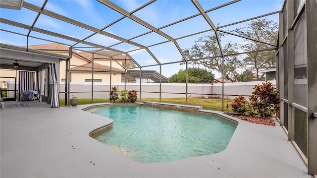 view of pool featuring glass enclosure and a patio area