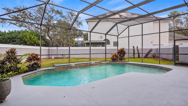 view of swimming pool with a yard, a patio, and a lanai