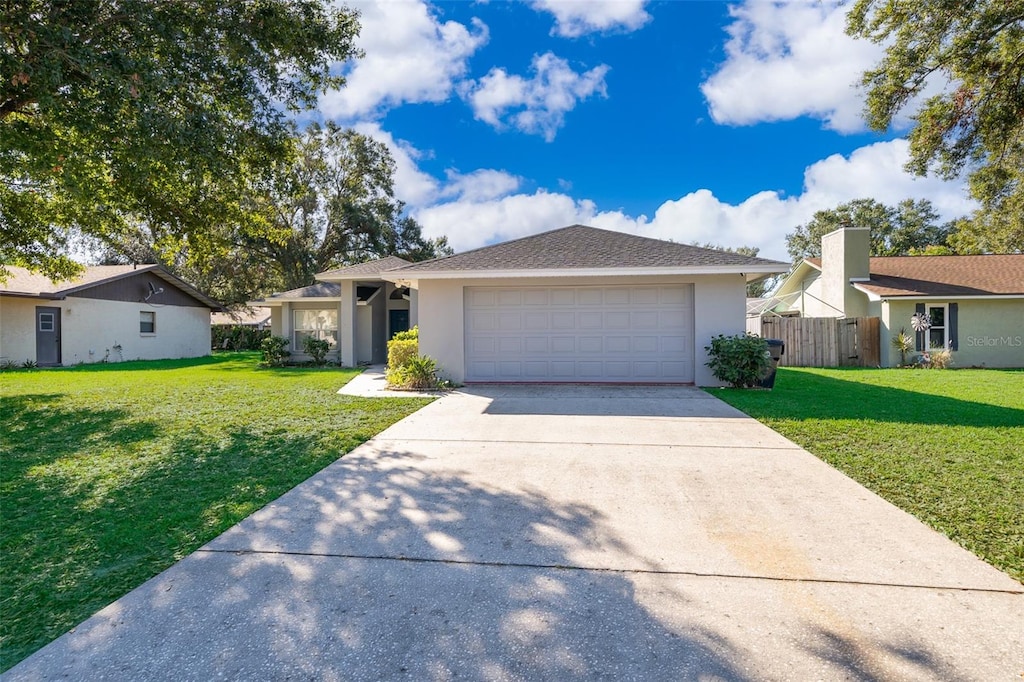 single story home featuring a front yard and a garage