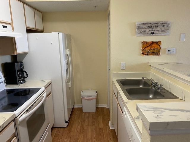 kitchen with exhaust hood, sink, white electric stove, white cabinets, and light hardwood / wood-style floors