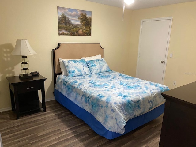 bedroom with dark hardwood / wood-style flooring