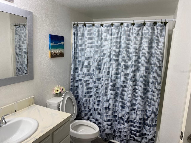 full bathroom with shower / bathtub combination with curtain, vanity, a textured ceiling, and toilet