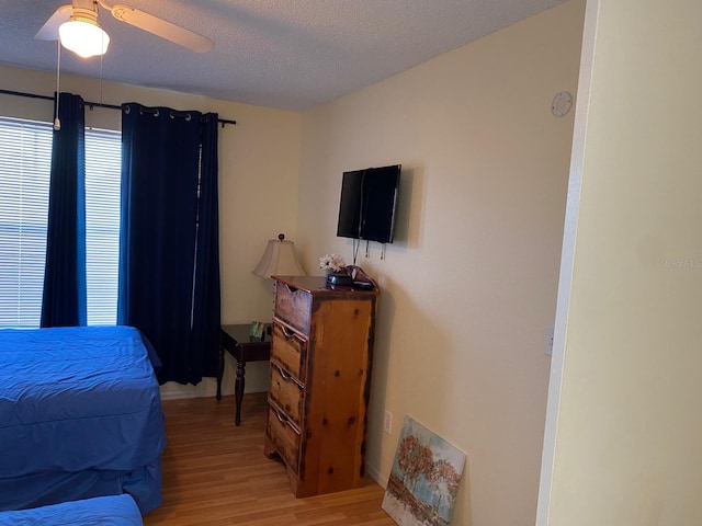 2202 Key W Ct Unit 632, Kissimmee, FL 34741 - bedroom with light wood finished floors, a textured ceiling, and a ceiling fan