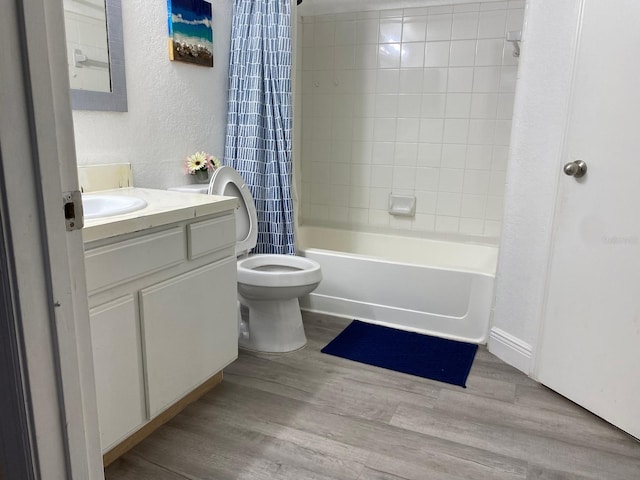 full bathroom featuring vanity, hardwood / wood-style flooring, toilet, and shower / bath combo with shower curtain