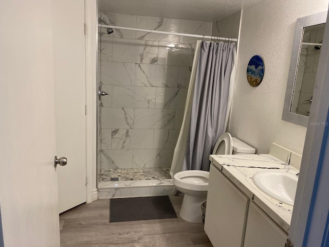 bathroom with a shower with shower curtain, vanity, toilet, and wood-type flooring