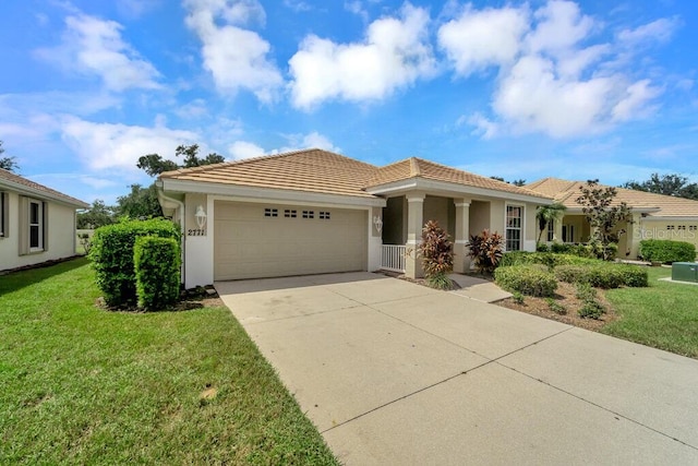 view of front facade with a garage and a front lawn