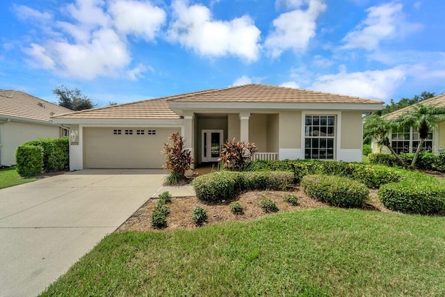 view of front of home with a garage and a front yard