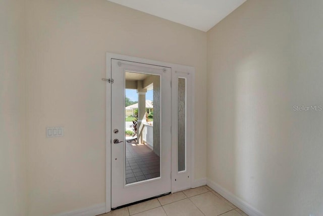 doorway to outside with light tile patterned floors