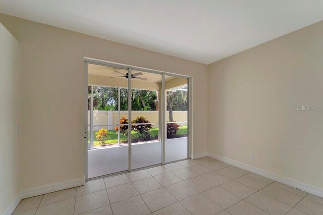 unfurnished room featuring light tile patterned floors and ceiling fan