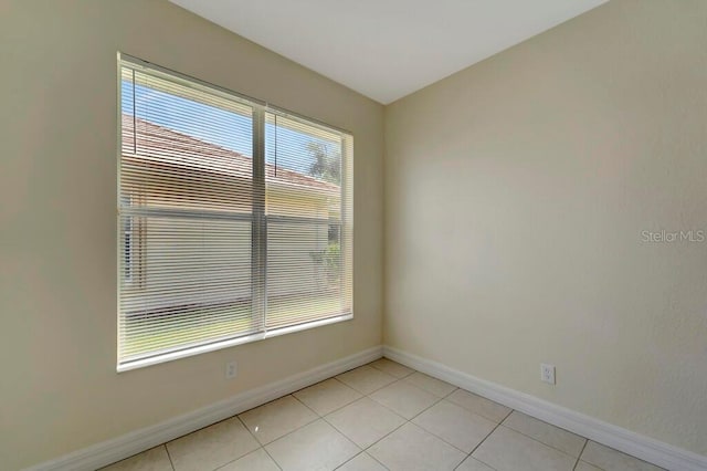 tiled empty room with a wealth of natural light