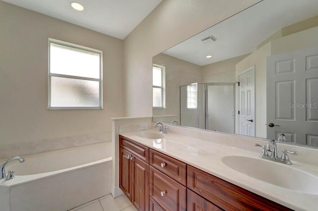 bathroom with tile patterned flooring, vanity, and independent shower and bath