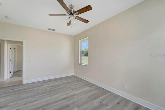 spare room featuring ceiling fan and light hardwood / wood-style floors