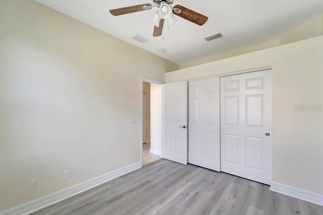 unfurnished bedroom with ceiling fan, a closet, and light hardwood / wood-style floors