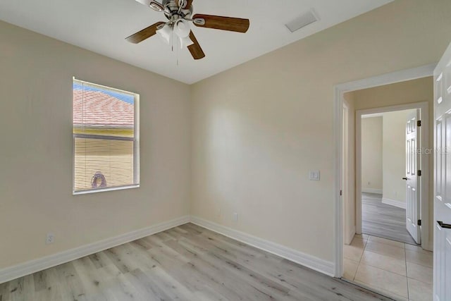 empty room with ceiling fan and light wood-type flooring