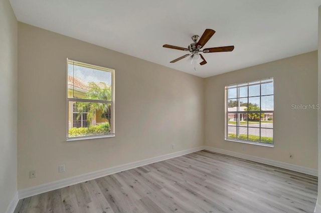 empty room with light hardwood / wood-style floors and ceiling fan