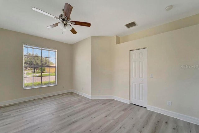 spare room with ceiling fan and light hardwood / wood-style flooring