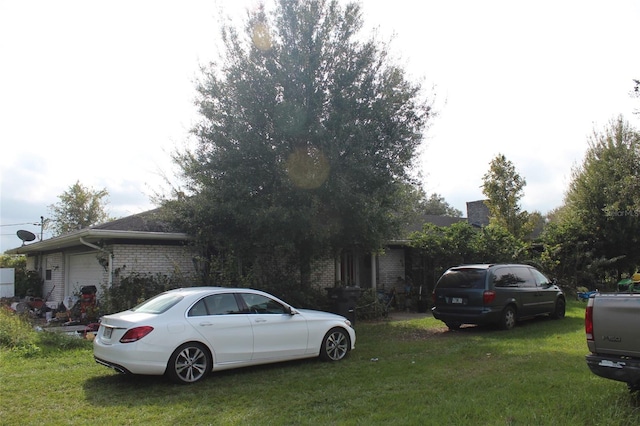 exterior space featuring a garage and a yard