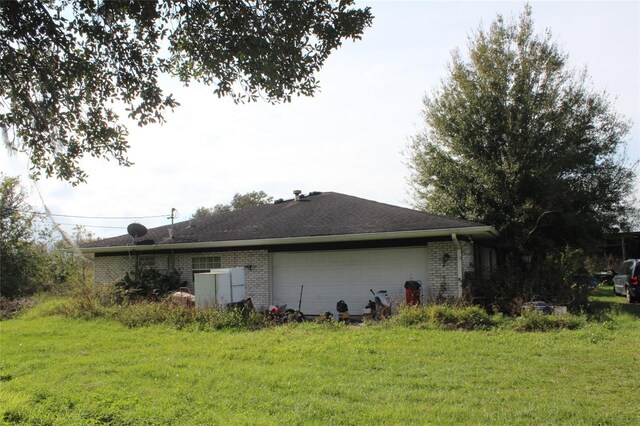 view of property exterior with a garage and a lawn