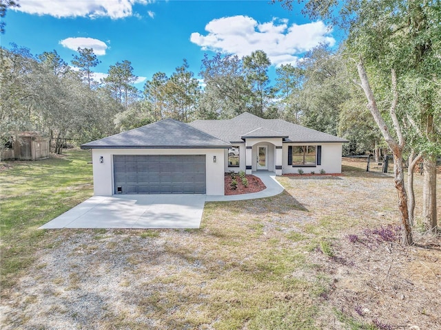 single story home with a garage and a front lawn