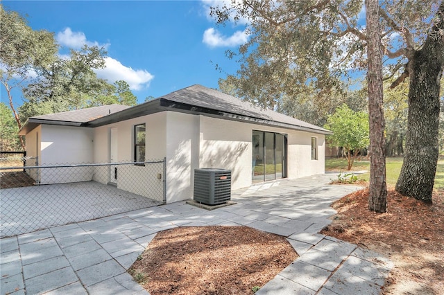 back of property with a patio and central AC unit