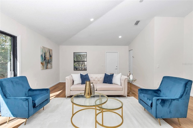 living room featuring light hardwood / wood-style floors and lofted ceiling