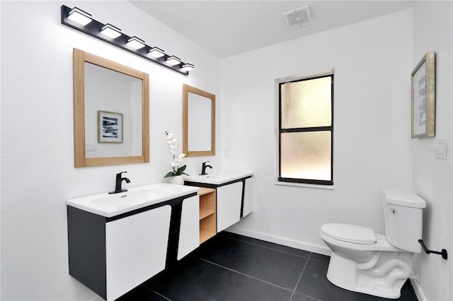 bathroom featuring tile patterned floors, vanity, and toilet