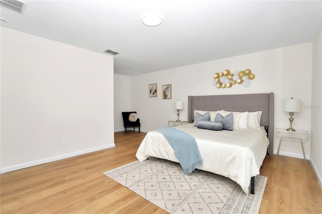 bedroom with hardwood / wood-style flooring