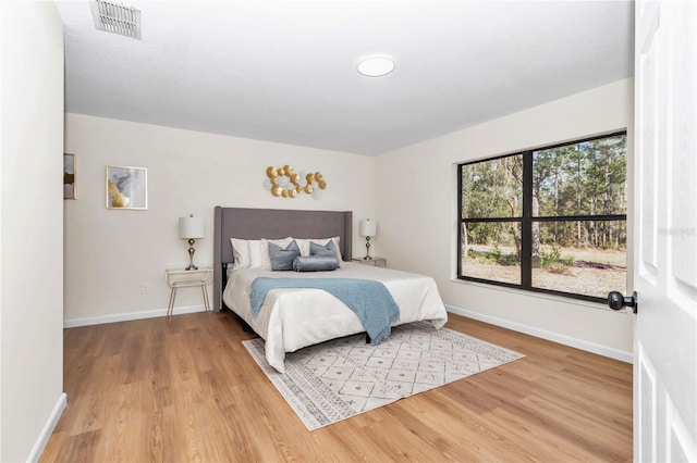 bedroom with wood-type flooring