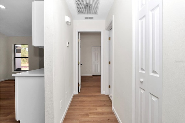 hallway with light hardwood / wood-style flooring