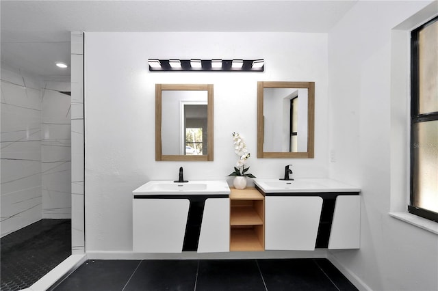 bathroom featuring tiled shower, vanity, and tile patterned floors