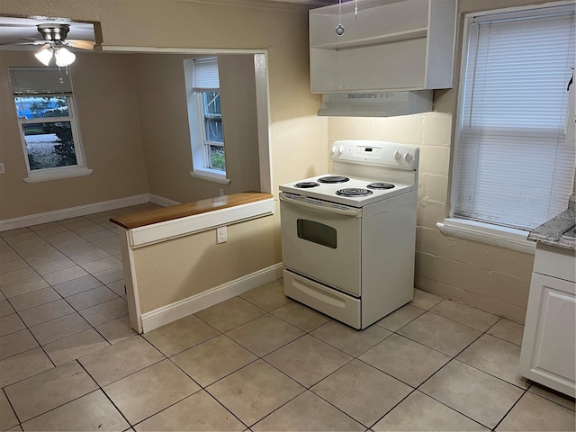 kitchen featuring white cabinets, a wealth of natural light, electric range, and ceiling fan