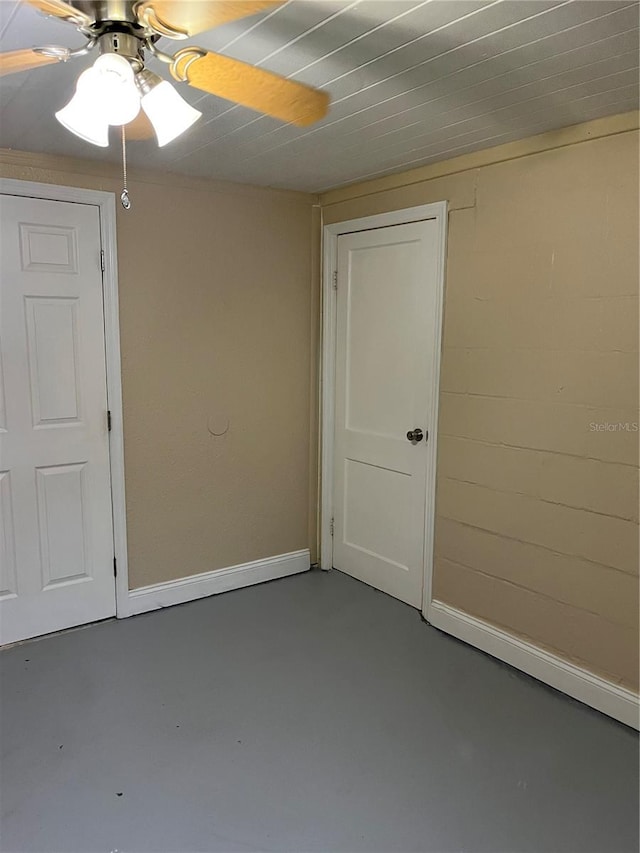 spare room featuring concrete flooring and ceiling fan