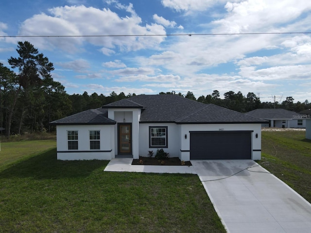 view of front of home featuring a front lawn and a garage