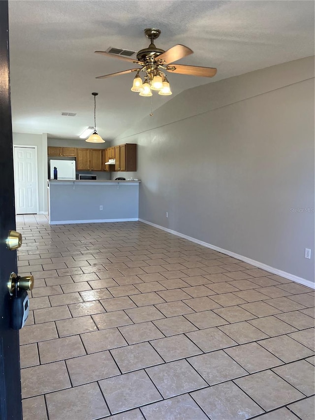 unfurnished living room with ceiling fan and lofted ceiling