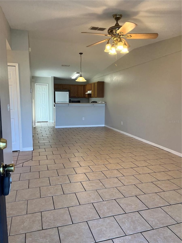 unfurnished living room featuring ceiling fan and light tile patterned flooring