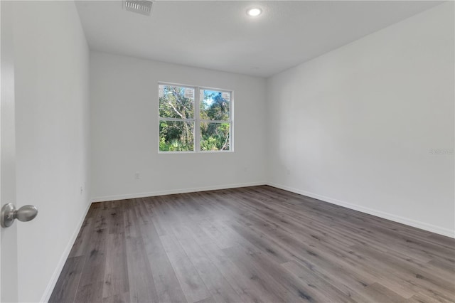 spare room with wood-type flooring