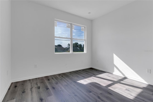 unfurnished room with hardwood / wood-style flooring