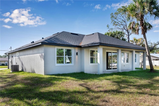 back of property featuring a yard and central AC unit