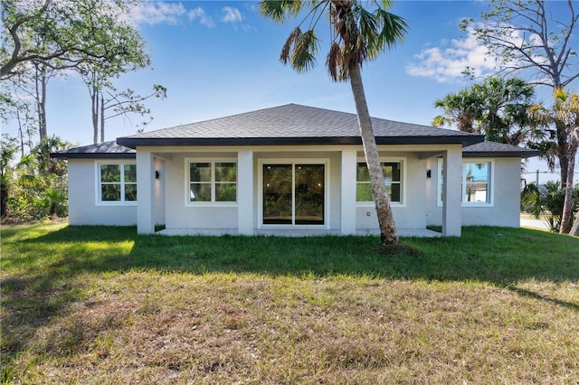 back of property featuring a lawn