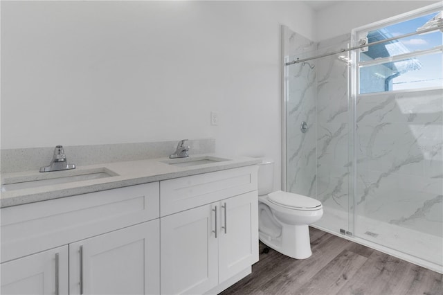 bathroom with toilet, vanity, an enclosed shower, and hardwood / wood-style flooring