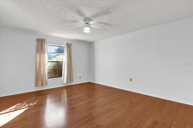 empty room featuring ceiling fan, a textured ceiling, and hardwood / wood-style flooring