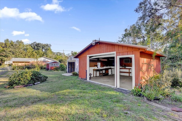 view of outbuilding featuring a lawn