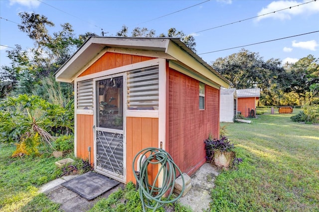 view of outbuilding featuring a yard