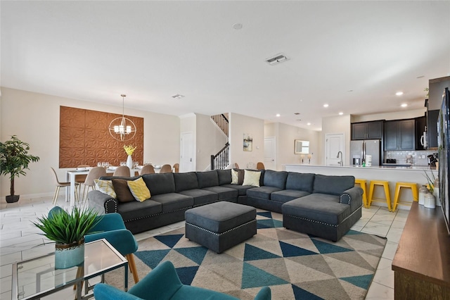 tiled living room with an inviting chandelier