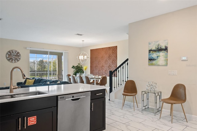 kitchen with dishwasher, pendant lighting, a notable chandelier, and sink