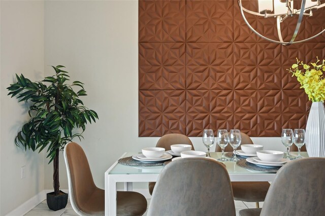 dining space with light tile patterned floors and a chandelier