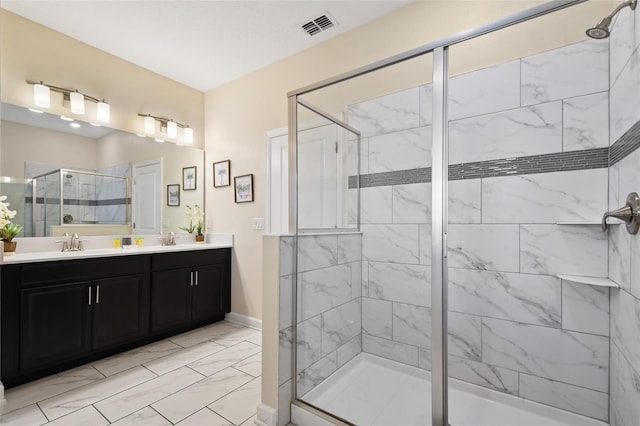 bathroom with a shower with door and vanity