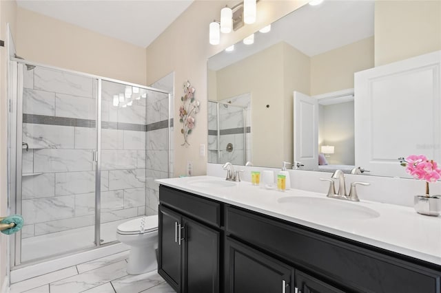 bathroom featuring vanity, toilet, and an enclosed shower