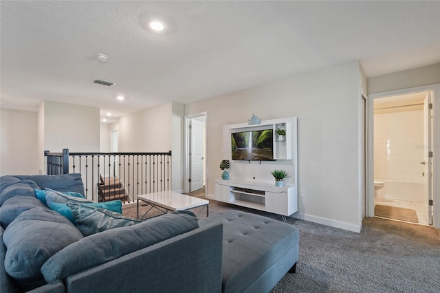 living room with dark carpet and a textured ceiling